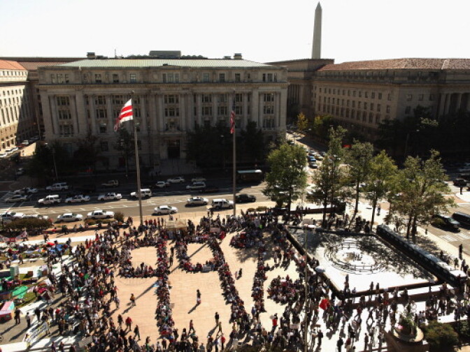 About one thousand people gather and form a large '99%' in the middle of Freedom Plaza during an 'occupation' of the plaza October 6, 2011 in Washington, DC. Inspired by the Occupy Wall Street movement that began last month in New York, large and small occupations have sprung up in cities across the country.