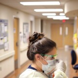 LEONARDTOWN, MARYLAND - MARCH 24:  Nurses in the COVID-19 unit of MedStar St. Mary's Hospital check the fit of protective equipment before entering a patient's room March 24, 2020 in Leonardtown, Maryland. MedStar St. Mary’s Hospital is located near the greater Washington, DC area in St. Mary’s county, Maryland. Hospitals around the United States are continuing to prepare for an expected onslaught of cases related to COVID-19 in the days ahead. (Photo by Win McNamee/Getty Images)