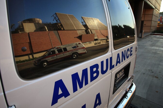 LOS ANGELES, CA - OCTOBER 09:  An ambulance transporting a patient is reflected in the window of another ambulance at Ronald Reagan UCLA (University of California Los Angeles) Medical Center on October 9, 2008 in Los Angeles, California. California State Treasurer Bill Lockyer has warned that California cash revenues will run out by the end of the month. If that happens, 5,000 California cities, counties, and school districts will face job layoffs and payments for law enforcement agencies, nursing homes, teachers, and other services and government entities could be suspended. A worldwide credit crunch threatens to derail state plans for a routine 7 billion dollar loan to even out the tax flow into the state treasury. Just two weeks after state lawmakers came to agreement, after months of haggling on a record-overdue state budget, California Gov. Arnold Schwarzenegger is warning of future cuts to the state budget to deal with skyrocketing financial problems. A frozen credit market and revenues for the first quarter of the fiscal year that fell more than a billion dollars short of previous projections are causing the governor and state legislative leaders scrabbling to deal with a new budget mess.    (Photo by David McNew/Getty Images)