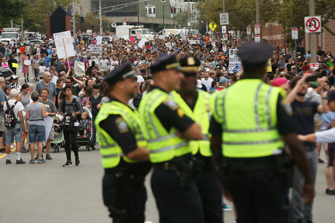 Police stand by as thousands of protesters prepare to march in Boston against a planned 'Free Speech Rally' just one week after the violent 'Unite the Right' rally in Virginia
