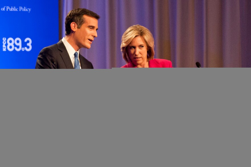 City Councilman Eric Garcetti and City Controller Wendy Greuel check the time, minutes before a 7 p.m. mayoral debate at USC Health Sciences Campus in Mayer Auditorium on Monday.