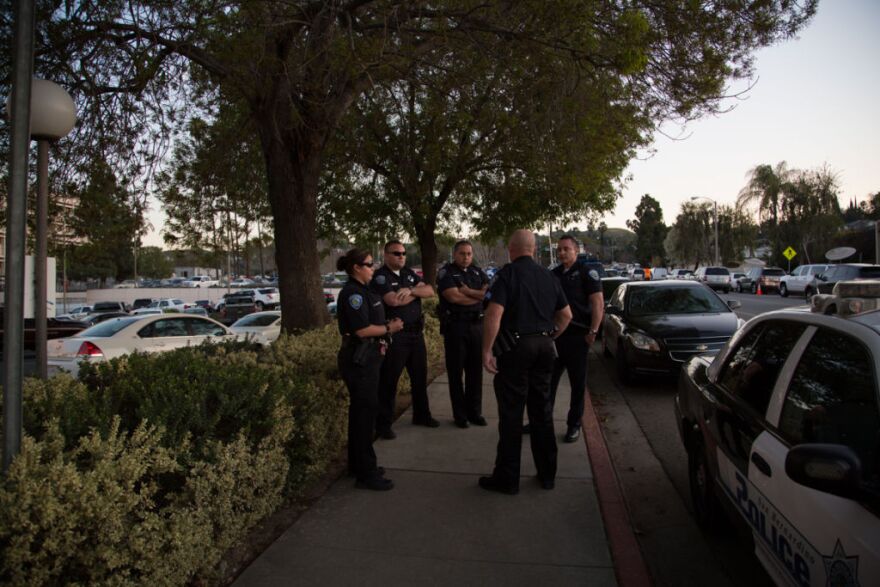 San Bernardino cops wait outside Loma Linda hospital.