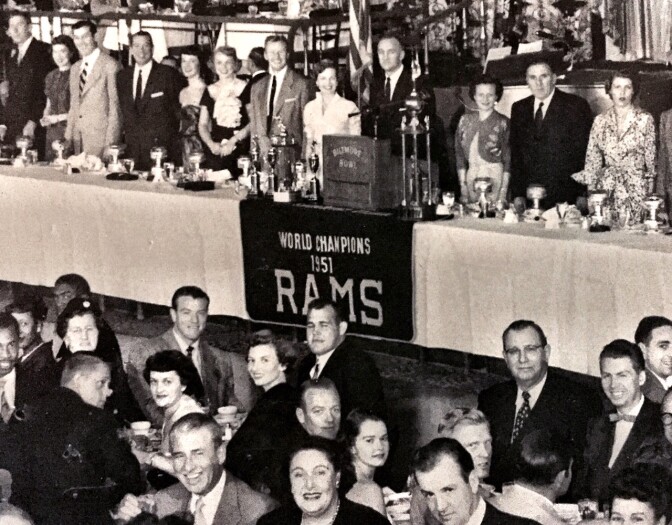 A celebratory banquet, with the Rams banner, which now hangs at Tom Bergin's, draped in front of the podium. 