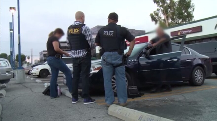 This screen capture from a video ICE released Friday, Aug. 14, 2015 shows a scene from Operation No Safe Haven II, which ended in the arrests of 7 fugitives in Southern California and 50 nationwide.