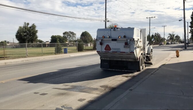 A garbage truck drives along Nichols Lane, which separates Oak Park Elementary School from the waste transfer station operated by Republic Services.