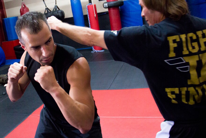 Benny "The Jet" Urquidez, right, and “Take Two” host A Martinez practice defensive techniques at the Team Karate Center in Woodland Hills.