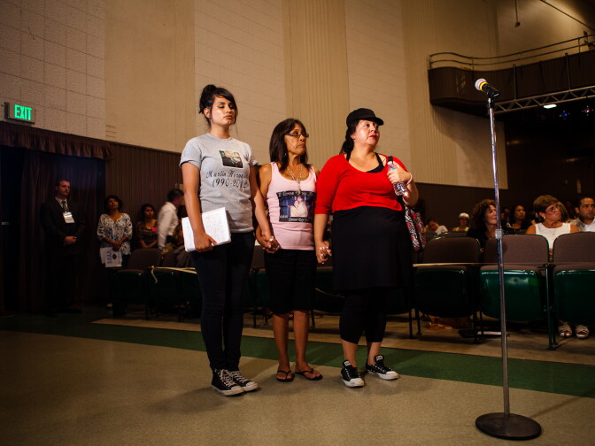 Sonia Hernandez, 20, Theresa Smith, and Dawn Acevedo, wait to speak to the City Council during a special meeting on August 8, 2012. All three women lost family members in recent Anaheim police involved shootings. After Smith lost her son Caesar Cruz in 2009, she formed a support group, Anaheim Cruzaders, to help others who have lost loved ones in police shootings.