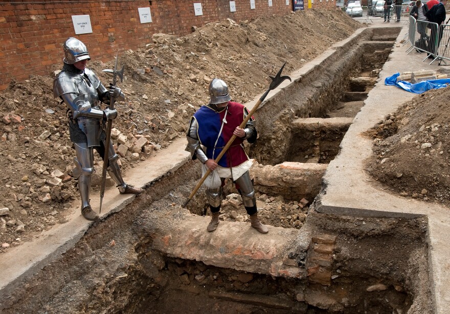 Men dressed as medieval knights pose for pictures in Leicester in central England, on September 12, 2012, at a site where a skeleton that researchers believe could be British medieval king Richard III was found.