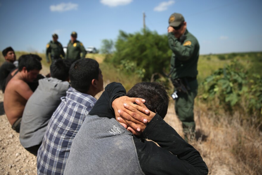 MCALLEN, TX - AUGUST 07:  U.S. Border Patrol agents detain undocumented immigrants after they crossed the border from Mexico into the United States on August 7, 2015 in McAllen, Texas. The state's Rio Grande Valley corridor is the busiest illegal border crossing into the United States. Border security and immigration have become major issues in the U.S. presidential campaigns.  (Photo by John Moore/Getty Images)