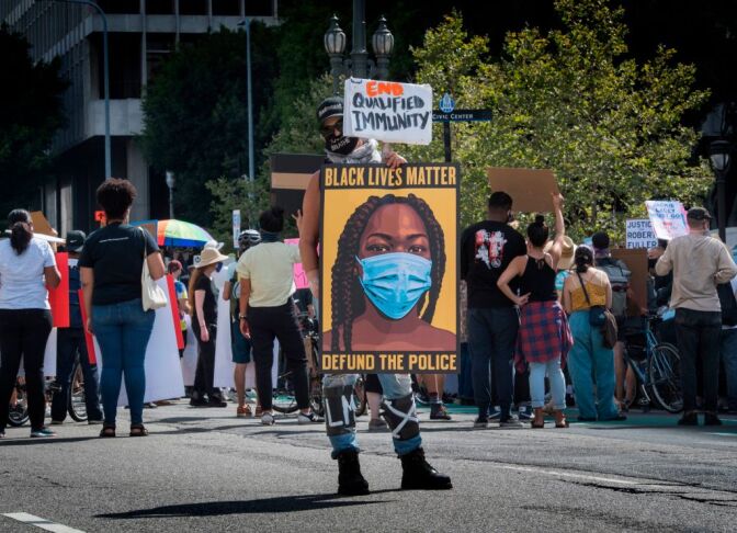 People protest against the death of George Floyd and others in police custody, as they support the Black Lives Matter movement outside the Hall of Justice in Los Angeles, California on June 24, 2020. (Photo by Mark RALSTON / AFP) (Photo by MARK RALSTON/AFP via Getty Images)