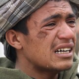 An Afghan youth mourns for relatives, who were allegedly killed by a U.S. service member in Panjwai, Kandahar province south of Kabul, Afghanistan, Sunday, March. 11, 2012. A U.S. service member walked out of a base in southern Afghanistan before dawn Sunday and started shooting Afghan civilians, according to villagers and Afghan and NATO officials.