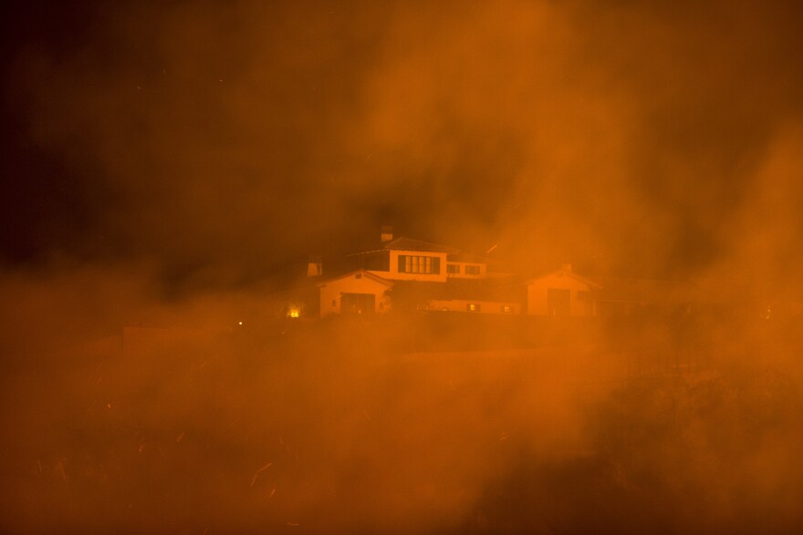 The Thomas Fire approaches a home on December 12, 2017 in Montecito, California.