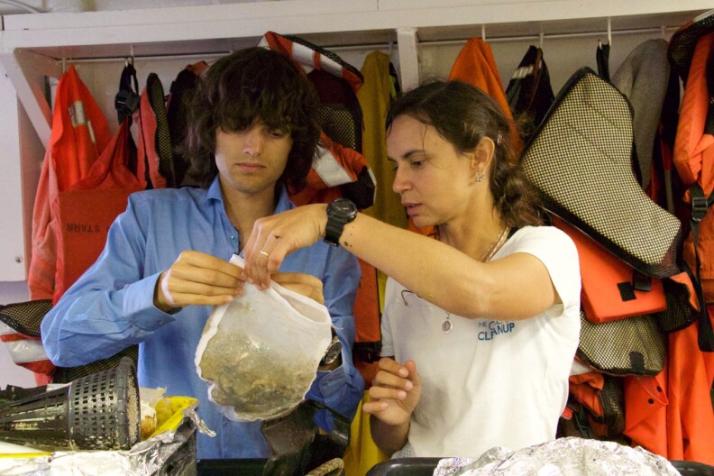 The Ocean Cleanup CEO and founder Boyan Slat and Julia Reisser, lead oceanographer, examining samples of the Great Pacific Garbage Patch, aboard Mega Expedition mothership R/V Ocean Starr.