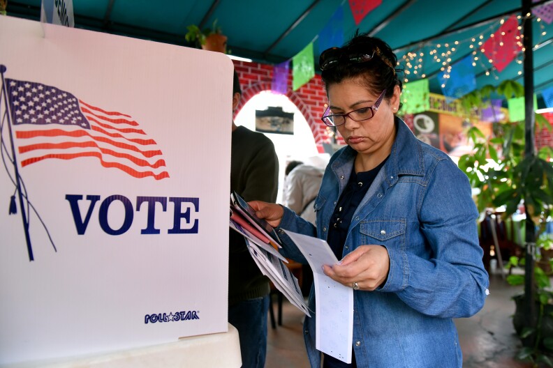 Rosa Ayala checks her ballot after voting in the US presidential primary June 7, 2016 at Sabores de Oaxaca, a Mexican restaurant in Los Angeles, California.  / AFP / Michael Owen Baker        (Photo credit should read MICHAEL OWEN BAKER/AFP/Getty Images)