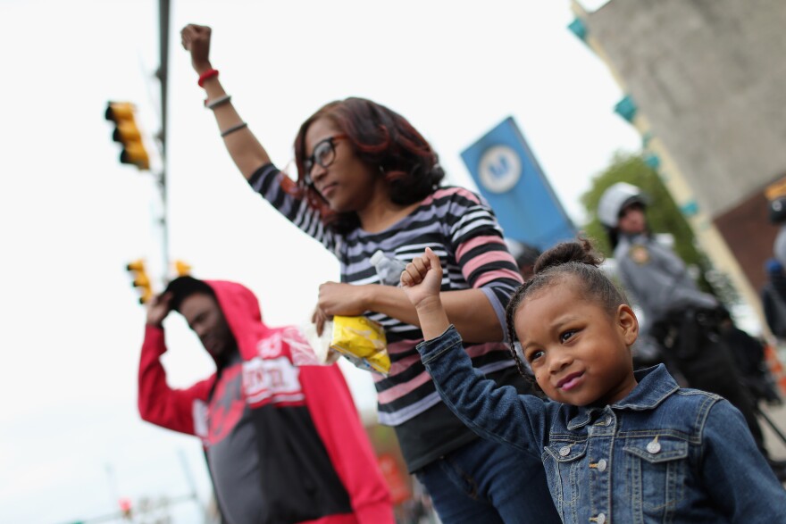 A young girl raises her fist along with others after Baltimore authorities released a report on the death of Freddie Gray on May 1, 2015, in Baltimore, Maryland. Marilyn Mosby, Baltimore City state's attorney, ruled the death of Freddie Gray a homicide and that criminal charges will be filed. Gray, 25, was arrested for possessing a switch blade knife April 12 outside the Gilmor Houses housing project on Baltimore's west side. According to his attorney, Gray died a week later in the hospital from a severe spinal cord injury he received while in police custody. 