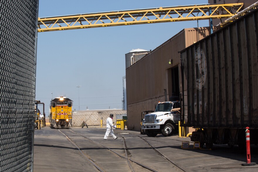 An employee wearing a breathing mask works at Exide Technologies, a battery recycling plant has discharged harmful amounts of lead into surrounding communities.