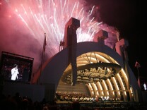 Fireworks erupt during the finale as Gustavo Dudamel makes his Hollywood Bowl debut as director of the Los Angeles Philharmonic in Los Angeles on Saturday, Oct. 3, 2009. The 28-year-old Venezuelan conductor was welcomed with a free community concert entitled "¡Bienvenido Gustavo!" Dudamel conducted the Los Angeles Philharmonic in Beethoven's Symphony No. 9 in D minor, Op 125. (AP Photo/Jason Redmond)