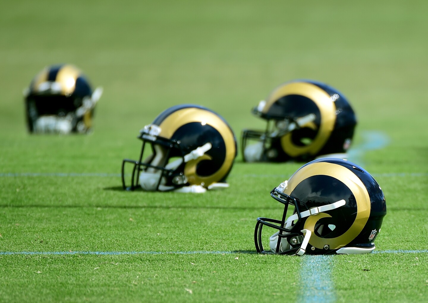 File: Los Angeles Rams helmets lay on the field during an L.A. Rams rookie camp on May 6, 2016 in Oxnard.
