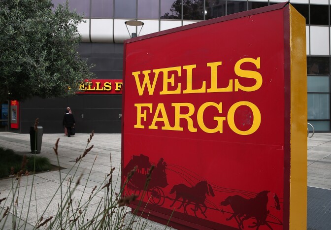 OAKLAND, CA - OCTOBER 11:  A sign is posted in front of a Wells Fargo bank on October 11, 2013 in Oakland, California. Wells Fargo reported a 13 percent increase in third-quarter profits with a net income of $5.6 billion, or 99 cents a share compared to $4.9 billion, or 88 cents a share one year ago.  (Photo by Justin Sullivan/Getty Images)