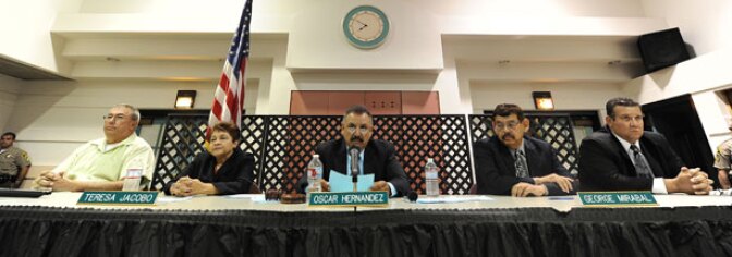 File photo: (L-R) City of Bell council members Lorenzo Velez, vice mayor Teresa Jacobo, mayor Oscar Hernandez, Councilman George Mirabel and Councilman Luis Artiga listen to residents asking them to resign during a council meeting on July 26, 2010 in Bell, California.