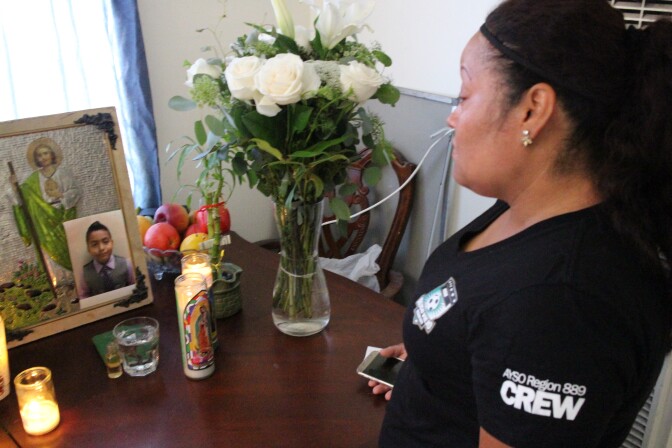 Teresa Dominguez, the mother of 14-year-old Jesse Romero, looks over a memorial for Romero, who was shot and killed by police in Boyle Heights on Tuesday.