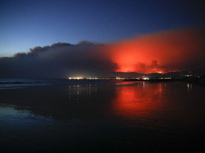 The glow of a wildfire as it burns in Ventura, California on Tuesday, Dec. 5, 2017. The Thomas Fire forced tens of thousands of people to evacuate their homes.