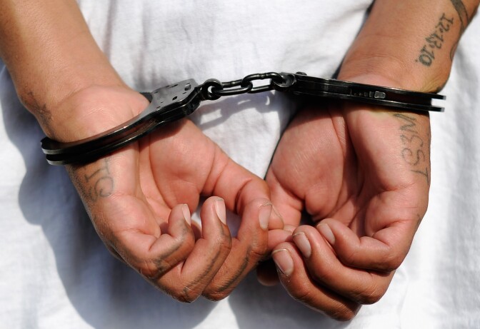 LOS ANGELES, CA - APRIL 29:  Handcuffs are seen on the hands of a twenty-year old "Street Villains" gang member who was arrested by Los Angeles Police Department officers from the 77th Street division on April 29, 2012 in Los Angeles, California. The 77th Street division patrol the same neighborhood that truck driver Reginald Denny was nearly beaten to death by a group of black assailants at the intersection of Florence and Normandie Avenues. It’s been 20 years since the verdict was handed down in the Rodney King case that sparked infamous Los Angeles riots.  (Photo by Kevork Djansezian/Getty Images)