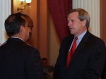 Sen. Mark DeSaulnier, D-Concord, discusses the budget revision package with colleagues during an all-night Senate session.