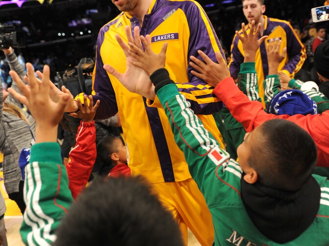 Paul Gasol of the Los Angeles Lakers is greeted on court by members of the Triqui children's basketball team, from Oaxaca, Mexico, at Staples Center on December 20, 2013 in Los Angeles, California. The children who have been called the 'Barefoot Champions of the Mountain,' welcomed the Lakers before their game against the Minnesota Timberwolves. 