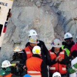 Chilean miner Claudio Yanez (R-in green) is hugged by a relative upon exiting the Fenix capsule after being brought to the surface in the eight place, on October 13, 2010 following a 10-week ordeal in the collapsed San Jose mine, near Copiapo, 800 km north of Santiago, Chile.