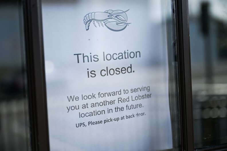 A simple printed black and white sign with text on it saying a restaurant has closed for business.