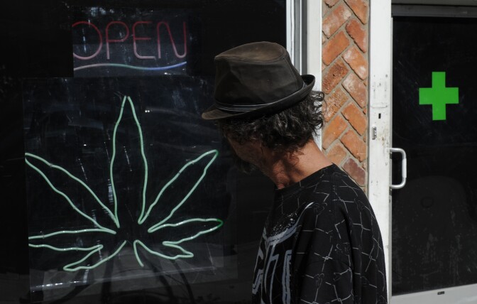 A man walks past a medicinal marijuana dispensary in Los Angeles,CA on November 2, 2010. Californians will vote today on whether to make their famously laid-back US state the world's first to legalize all marijuana consumption, cultivation and trade. Growing and selling marijuana for medicinal purposes has been legal here since 1996, but a hard-fought referendum held the same day as congressional and gubernatorial races would take it a step further. Proposition 19 -- one of a series of referendums held on November 2 -- would allow people aged 21 and over to possess up to one ounce (28 grams) of marijuana and grow up to 25 square feet (2.32 square meter) of pot plants.           AFP PHOTO/Mark RALSTON (Photo credit should read MARK RALSTON/AFP/Getty Images)