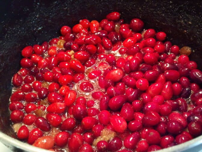 a pan of cranberries cooking, bright red in color