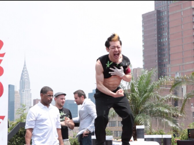 Competitive eater Takeru Kobayashi celebrates after breaking a hot dog eating record. Still from documentary "Hungry"