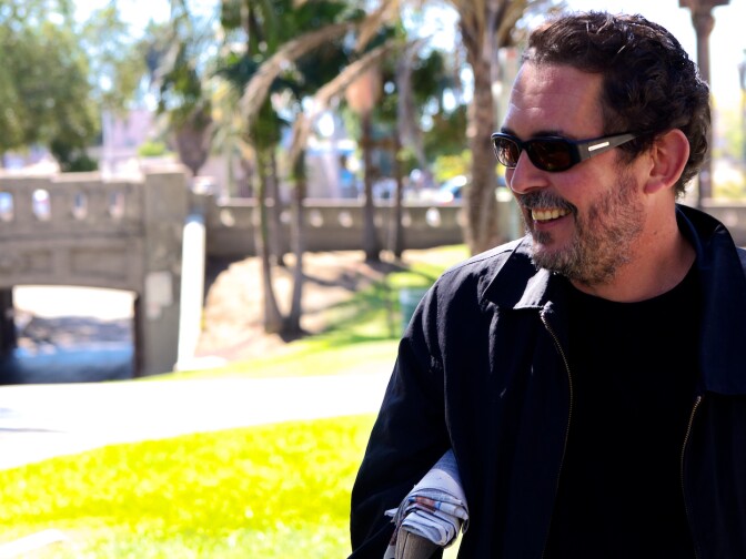 Author Richard Lange walking through MacArthur Park.