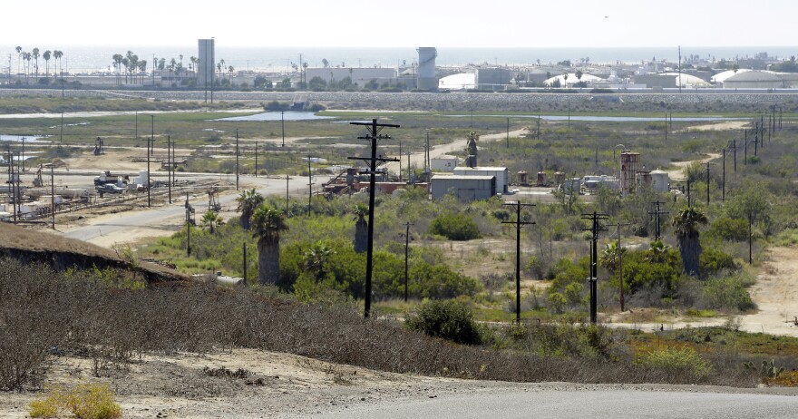 FILE - This Aug. 18, 2016, file photo shows Banning Ranch, including what remains of an oil-extraction operation, on what is believed to be the biggest piece of privately-owned vacant land on Southern California's coast in Newport Beach, Calif. Developers are suing the California Coastal Commission for more than $490 million in damages for failing to approve a project that would have turned a 401-acre stretch of oil land overlooking the Pacific Ocean into a housing and retail development. (AP Photo/Nick Ut, File)