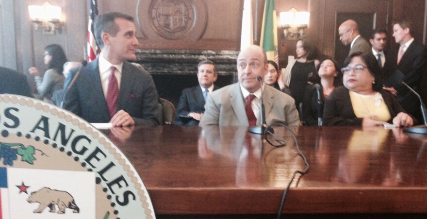 Mayor Eric Garcetti announces a $1.4 billion settlement of a lawsuit brought by disabled residents over broken city sidewalks and missing curb ramps. Attorney Guy Wallace, center, represented wheelchair user Lillibeth Navarro and other plaintiffs in the class action.