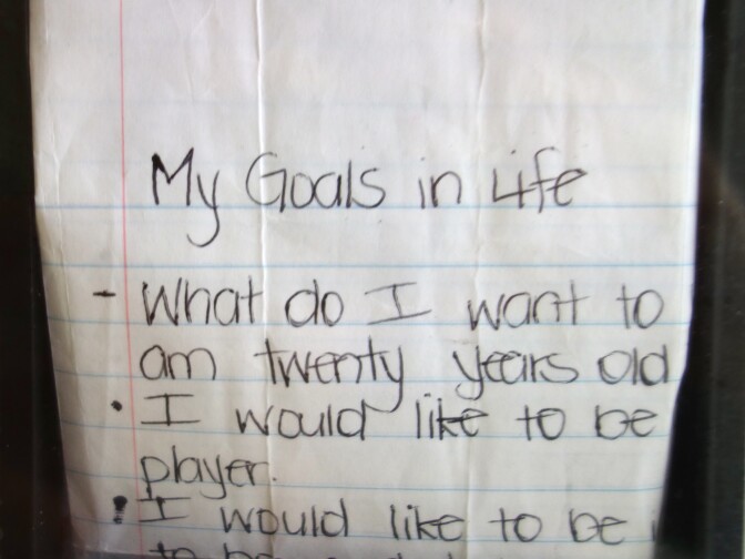 At age 16, Ezell Ford wrote his goals in life on a sheet of notebook paper. His great-aunt has kept it as part of a memorial photo collage.