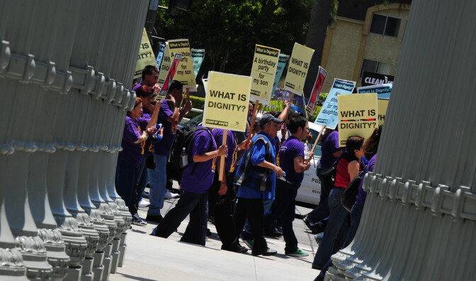 A  large group of janitors, security officers, airport workers and other contracted service workers, march and rally in front of the Los Angeles County Museum of Art (LACMA), to protest against, what they say are “low wages and benefits” in Los Angeles, California on June 15, 2011.