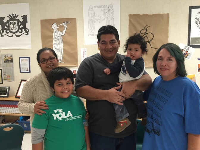 Luis Bonilla, left, with his parents, little brother, and music teacher René Rowland. 