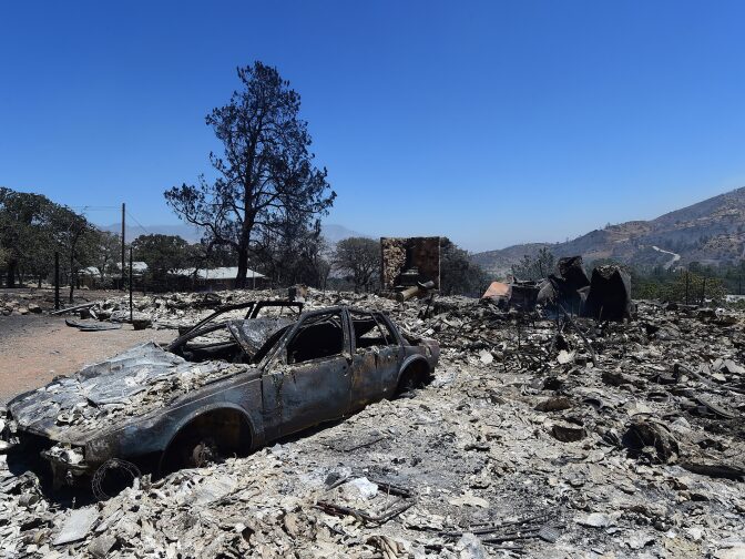 Rubble from a demolished home with vehicle out front are seen in the community of Squirrel Valley in Lake Isabella, California on June 24, 2016.