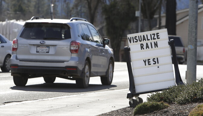 In this photo taken Tuesday, Feb. 4, 2014,  a sign outside a market in Willits, Calif., reminds passerby's about about the short water supply facing area residents. In the midst of a historic drought and area reservoirs holding less than a 100-day supply of water, Willits city leaders have banned lawn watering, car washing and mandated all residents to cut water use. (AP Photo/Rich Pedroncelli)