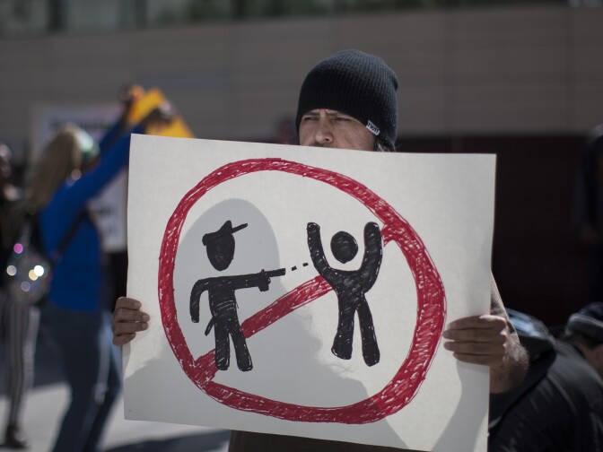 LOS ANGELES, CA - MARCH 3:  Protesters at Los Angeles Police Department Headquarters rally to express their anger over the fatal police shooting of an unarmed homeless man on March 3, 2015 in Los Angeles, California. Police say the homeless man, known by acquaintances as Africa, was shot dead by officers when he allegedly reached for the gun of one of several officers wrestling to the ground by his sidewalk tent. Amateur video of the controversial incident has been widely viewed over the internet    (Photo by David McNew/Getty Images)