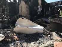 Fifteen homes were completely destroyed by the Canyon Fire 2 that raced through the Orange County hills in early October, fed by Santa Ana winds, heat and abundant, dry brush. Questions are now swirling over firefighters' initial response to the fire. 