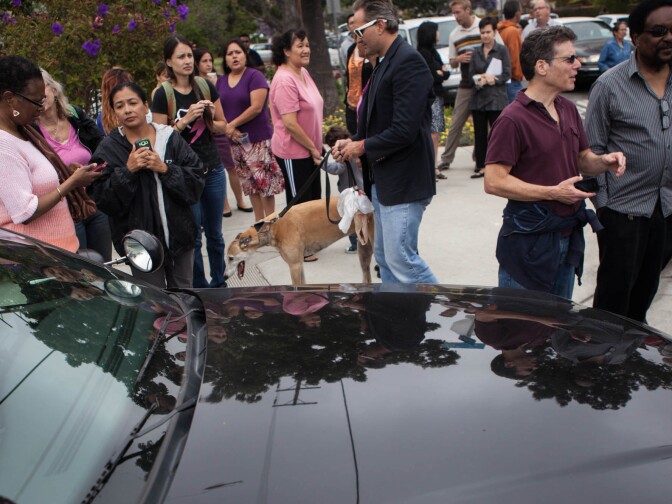 Bystanders talk about the events of the day near Santa Monica College.