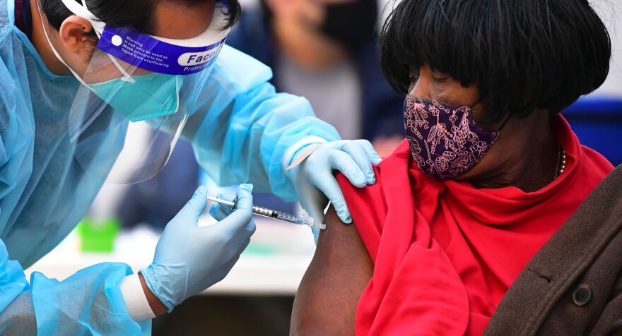 Registered Nurse Angelo Bautista administers the Moderna Covid-19 vaccine to eligible people identified by homeless service agencies from the parking lot of the L.A. Mission on February 24, 2021 in Los Angeles, California. (Photo by Frederic J. BROWN / AFP) (Photo by FREDERIC J. BROWN/AFP via Getty Images)