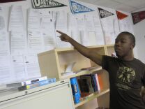 Douglass Academy 12th-grader David Berry points to lots of acceptance letters in the high school's college counseling office.