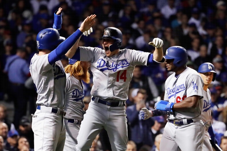 CHICAGO, IL - OCTOBER 19:  Enrique Hernandez #14 of the Los Angeles Dodgers celebrates with teammates after hitting a grand slam in the third inning against the Chicago Cubs during game five of the National League Championship Series at Wrigley Field on October 19, 2017 in Chicago, Illinois.  (Photo by Jamie Squire/Getty Images)