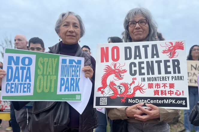 Two women with gray hair carry signs that read "No Data Center."