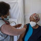 An health care worker administers a jab containing Pfizer vaccine on a caregiver of the SAVF Evanna Tehuis old age home near Klerksdorp, on May 19, 2021. South Africa is resuming its COVID-19 coronavirus Phase 2 vaccination rollout programme which targets vulnerable groups who are 60 years and older. (Photo by Michele Spatari / AFP) (Photo by MICHELE SPATARI/AFP via Getty Images)